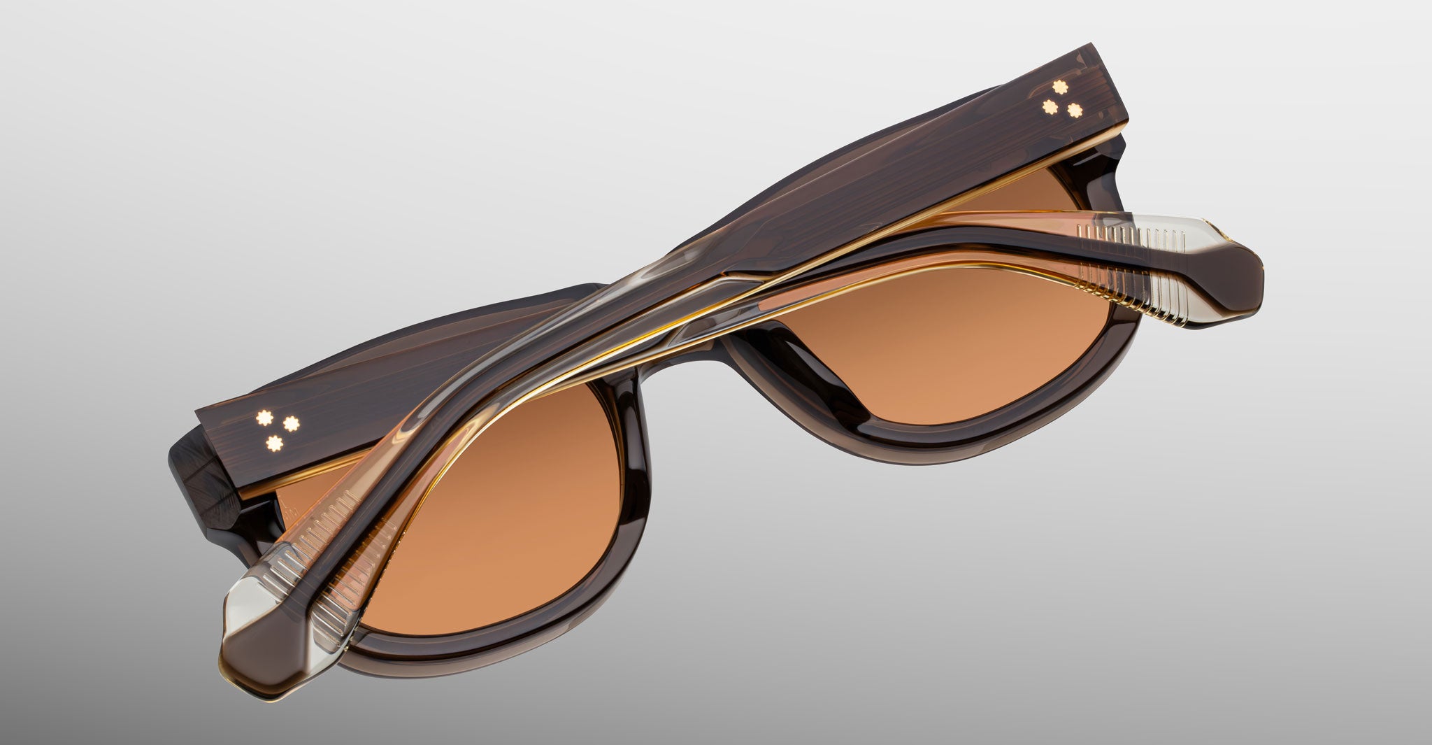 Jacques Marie Mage Amilcar sunglasses, brown, folded arms, top view.