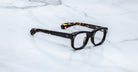Jacques Marie Mage Amilcar eyeglasses, thick black and tortoiseshell frames, top view.