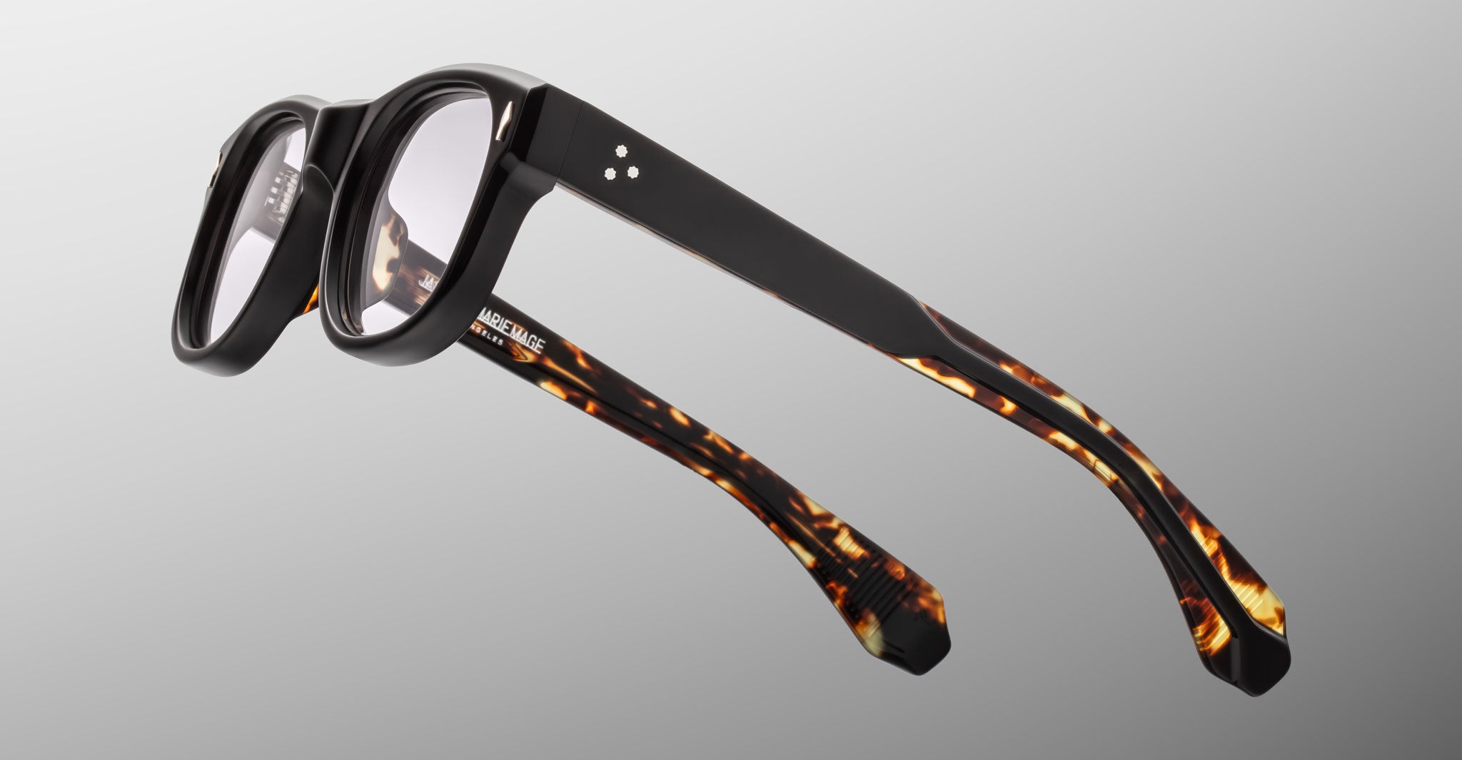 Jacques Marie Mage Amilcar eyeglasses with tortoiseshell arms and clear lenses, front view.