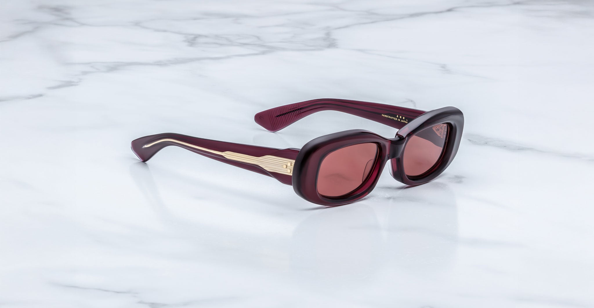 Jacques Marie Mage Ann in Amarena Red, side angle view highlighting sculpted temples and engraved wirecore detail