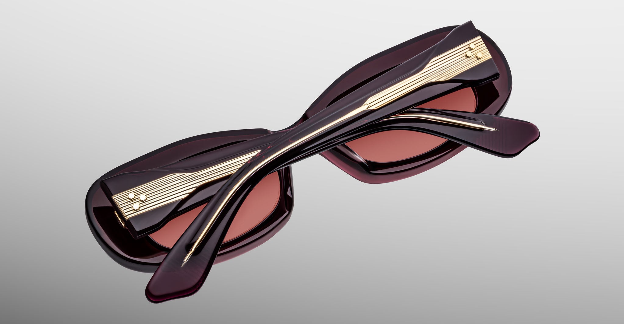 Jacques Marie Mage Ann in Amarena Red, back view showing crossed temples and exposed wirecore detail