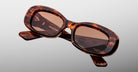 Jacques Marie Mage Ann in Bourbon, angled front view showing tortoise acetate frame and warm brown tinted lenses
