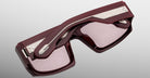 Top angled view of Jacques Marie Mage Apollo in Bordeaux Empire highlighting the deep burgundy acetate frame, beveled rectangular lenses with rose tint, sculpted temples with exposed engraved metal core, and signature arrowhead details.