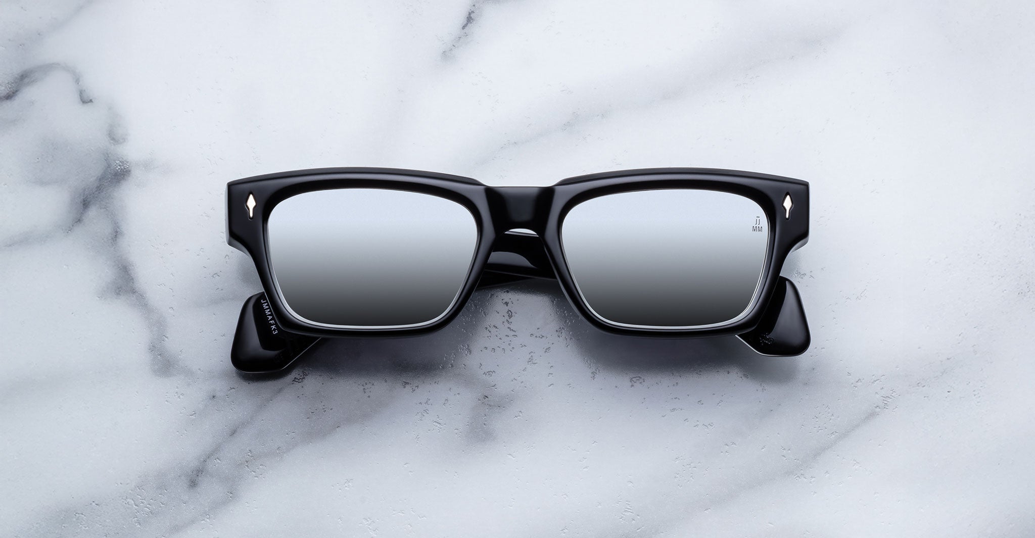 Jacques Marie Mage Ashcroft in Black Mirror acetate featuring a bold rectangular frame, signature arrowhead front pins, sculpted temples, and grey mirrored lenses