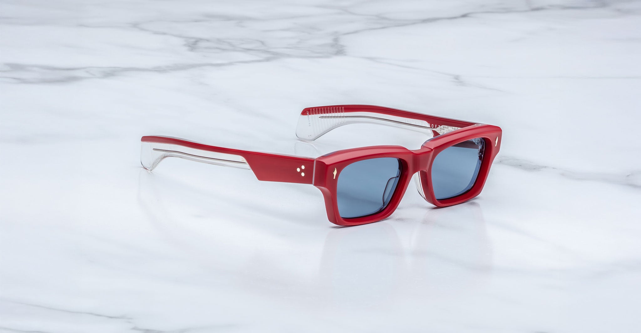 Jacques Marie Mage Ashcroft in Pirate acetate featuring a bold rectangular frame, signature arrowhead front pins, triple dot temple details, exposed wirecore temples, sculpted temple tips, and blue tinted lenses