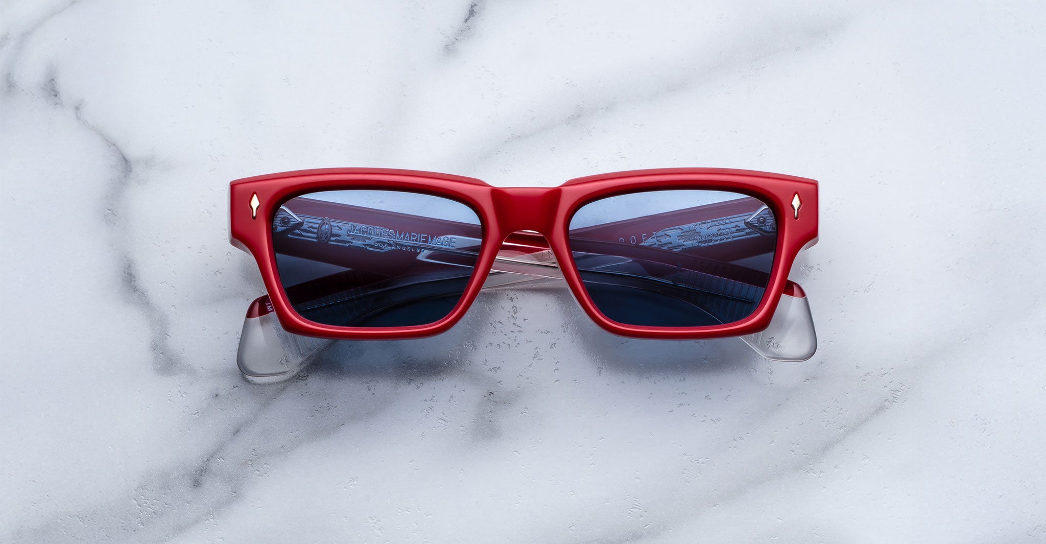 Jacques Marie Mage Ashcroft in Pirate acetate featuring a bold rectangular frame, signature arrowhead front pins, sculpted temples, and blue tinted lenses