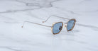 Jacques Marie Mage Atkins aviator sunglasses with blue lenses, viewed from above, showing full frame and lens color.