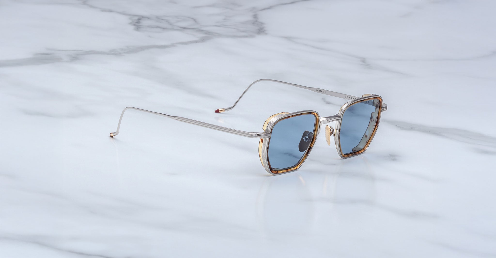 Jacques Marie Mage Atkins aviator sunglasses with blue lenses, viewed from above, showing full frame and lens color.