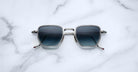 Jacques Marie Mage Atkins square sunglasses with dark lenses and silver rims, top view.