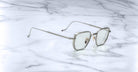 Jacques Marie Mage Atkins square silver eyeglasses with clear lenses, top-down view.