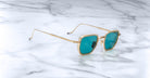 Jacques Marie Mage Atkins sunglasses, gold frames and blue lenses, top view.
