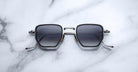 Jacques Marie Mage Atkins square sunglasses with dark lenses and silver frames, front view shown.