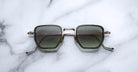Jacques Marie Mage Atkins square sunglasses with gold rims and UV-protective green lenses, top view.