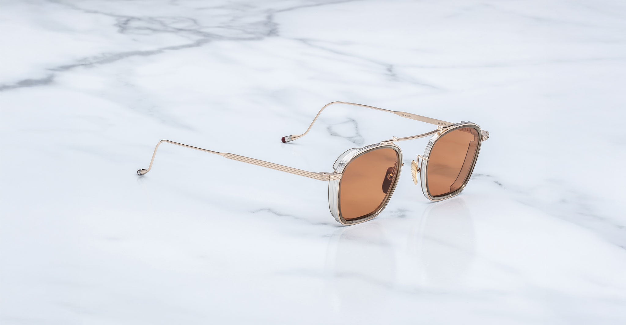Jacques Marie Mage Baudelaire 2 sunglasses with gold frames and brown lenses, front view.