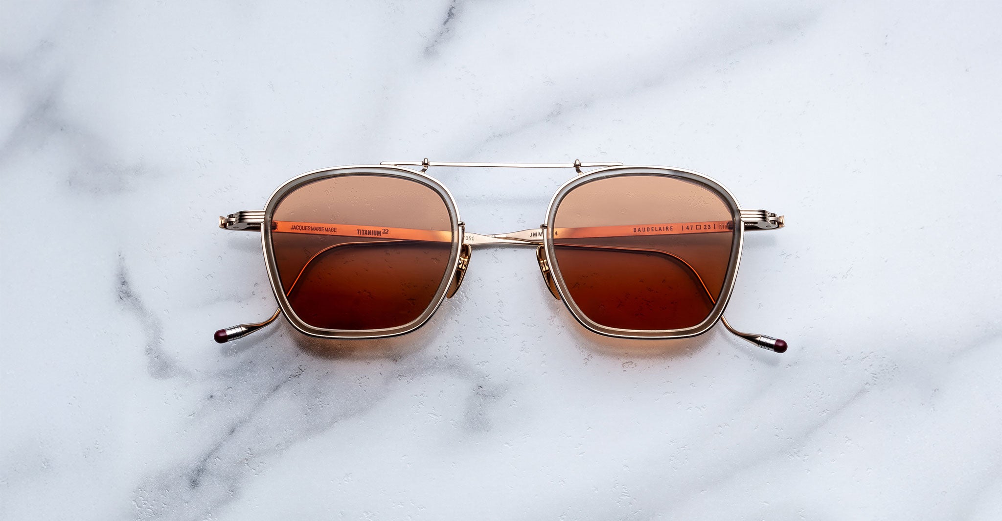Jacques Marie Mage Baudelaire 2 sunglasses with brown lenses, viewed from above.