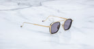 Jacques Marie Mage Baudelaire 2 aviator sunglasses with gold frames and dark lenses, front view.
