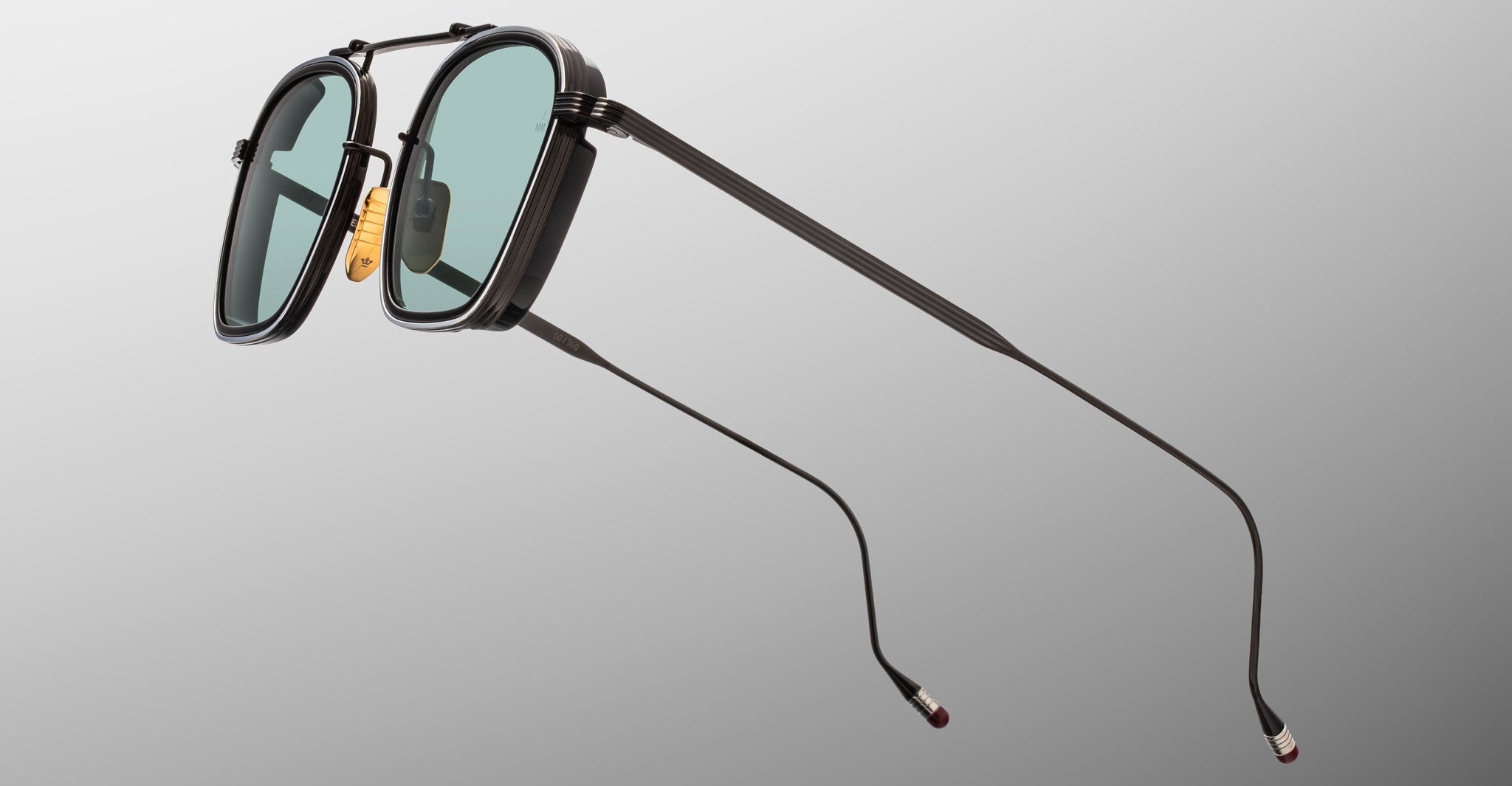 Jacques Marie Mage Baudelaire 2 sunglasses with teal lenses and slim arms, front-facing view.