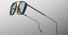 Jacques Marie Mage Baudelaire 2 sunglasses with teal lenses and slim arms, front-facing view.
