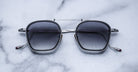 Jacques Marie Mage Baudelaire 2 silver sunglasses with UV protection, top view, showing metal frame and dark lenses.