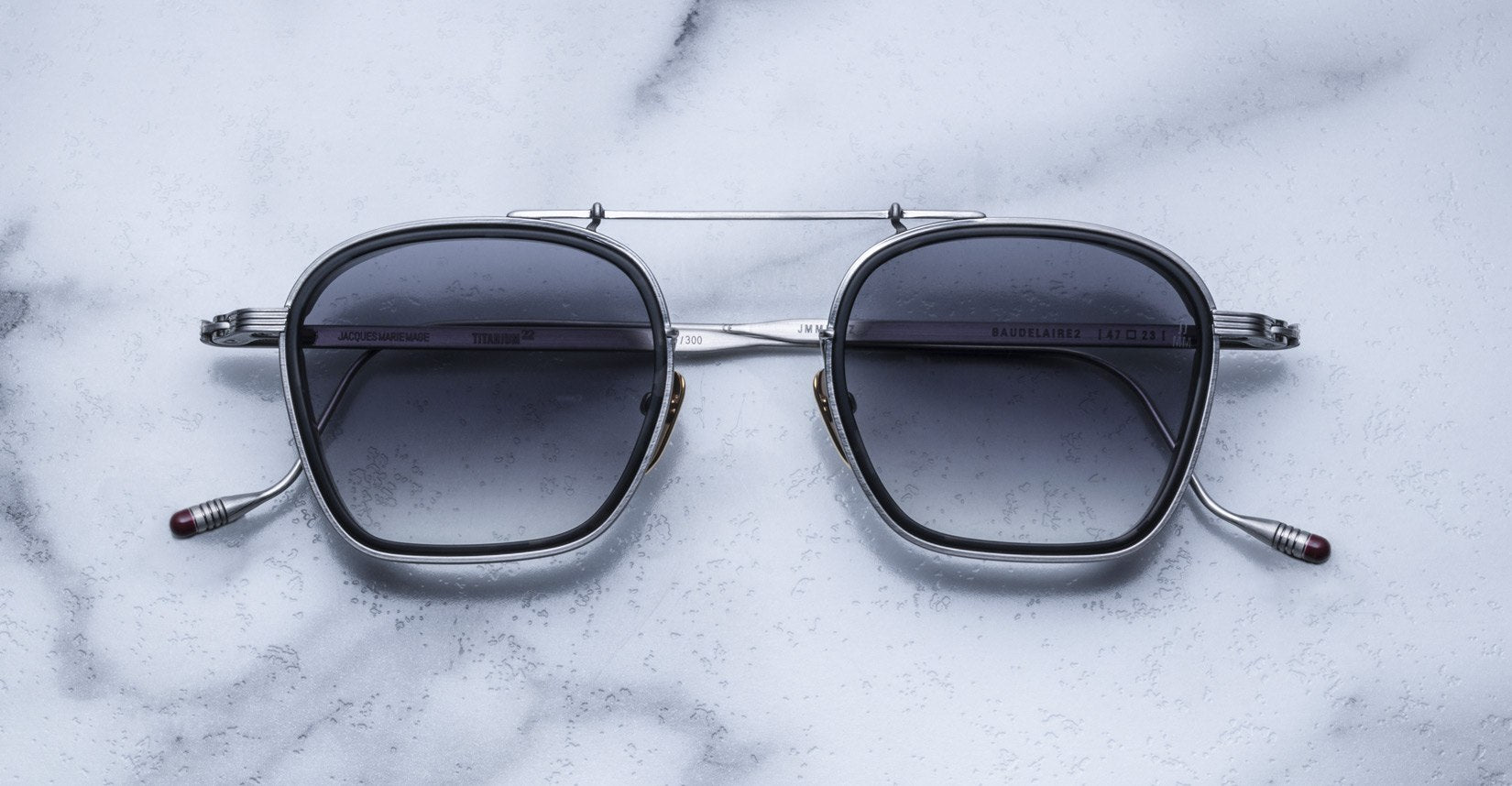Jacques Marie Mage Baudelaire 2 silver sunglasses with UV protection, top view, showing metal frame and dark lenses.