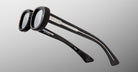 Jacques Marie Mage Besset sunglasses, black round thick frames, silver accents on arms, shown from the front angle.