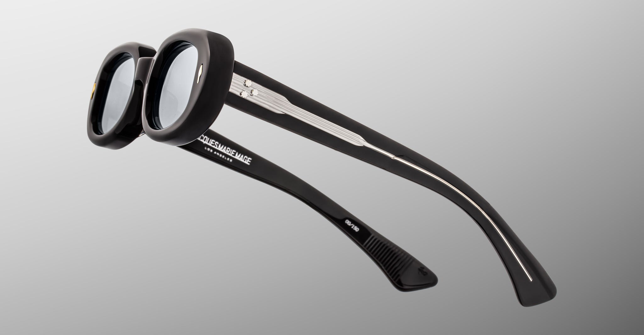 Jacques Marie Mage Besset sunglasses, black round thick frames, silver accents on arms, shown from the front angle.