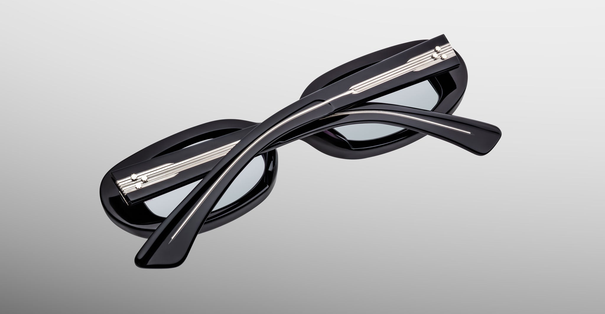 Jacques Marie Mage Besset black sunglasses with crossed temples, product side view.