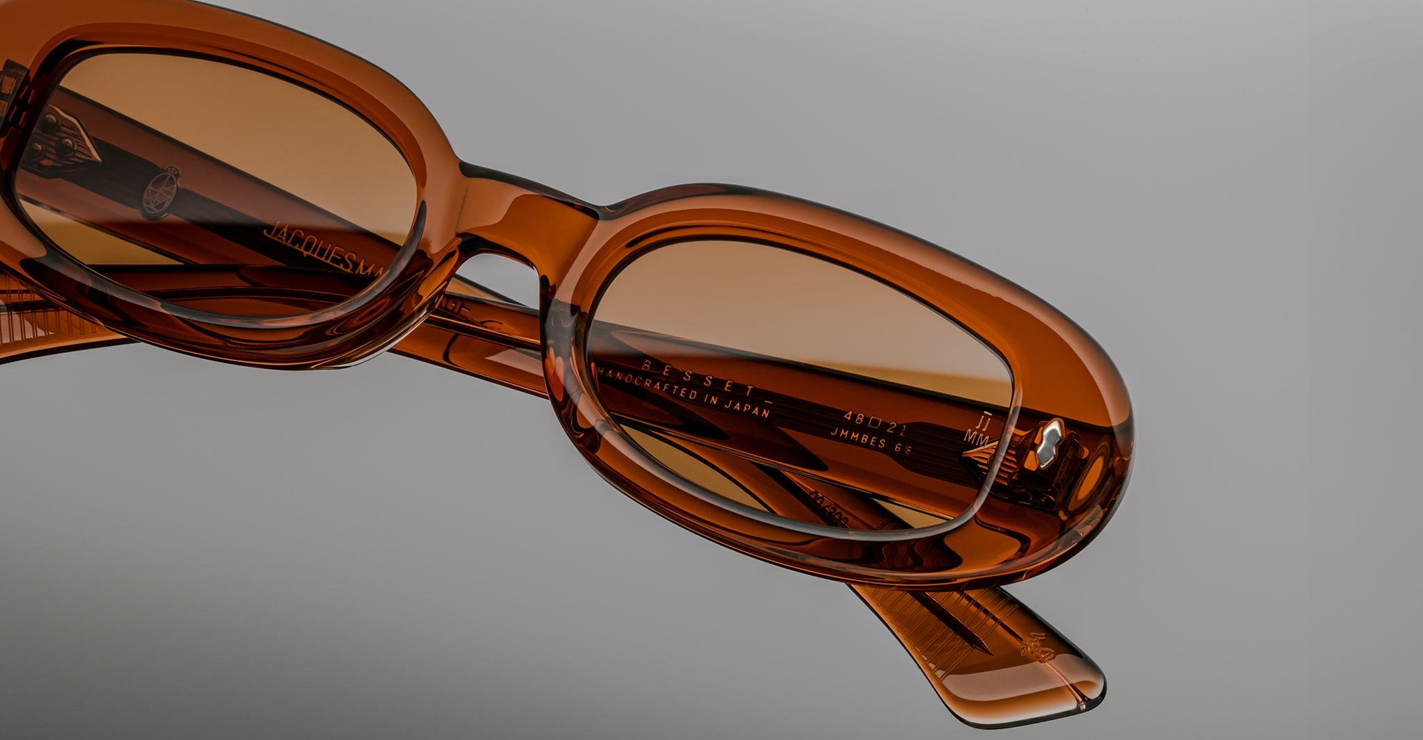 Jacques Marie Mage Besset brown acetate sunglasses, close-up angle showing engraved logo on the temple.