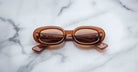 Jacques Marie Mage Besset sunglasses with thick brown rectangular frames, front view.