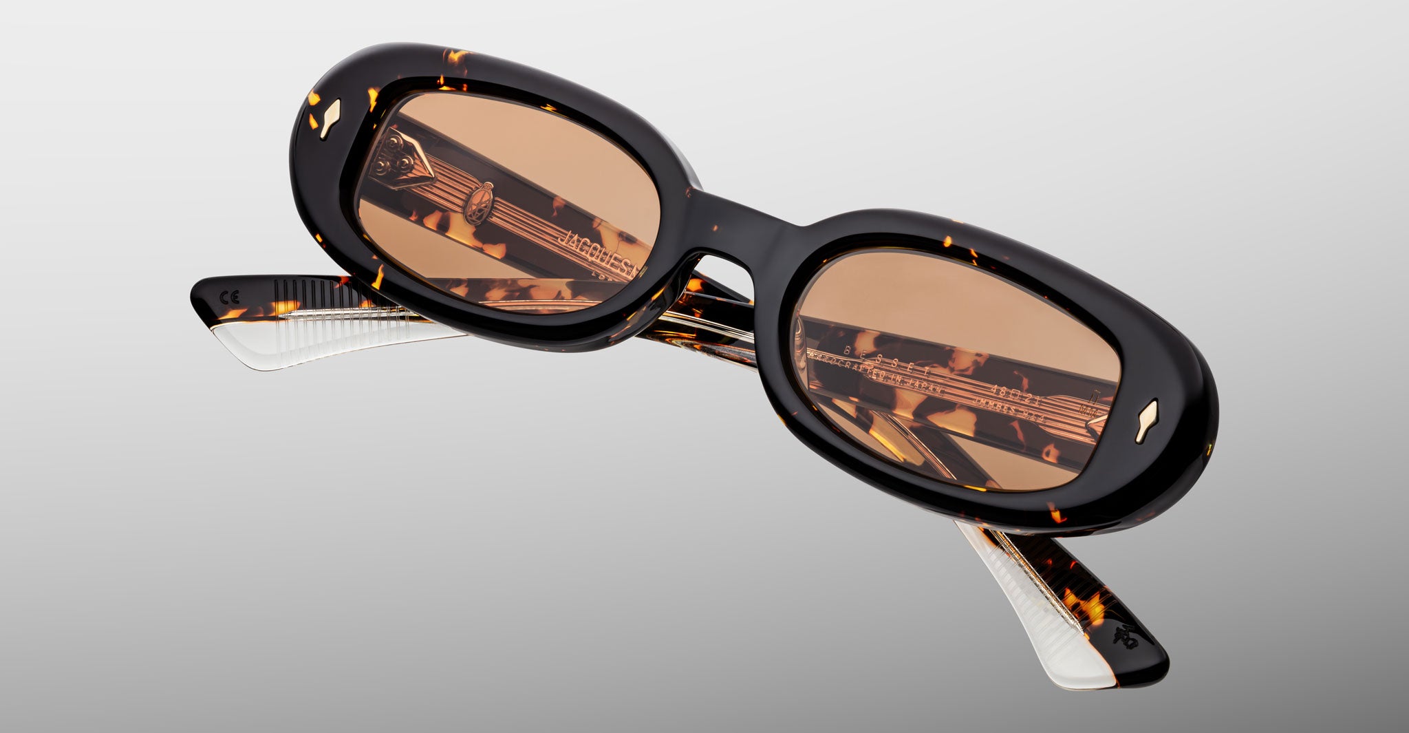 Jacques Marie Mage Besset sunglasses in brown and yellow tortoise shell pattern with orange lenses close-up front view