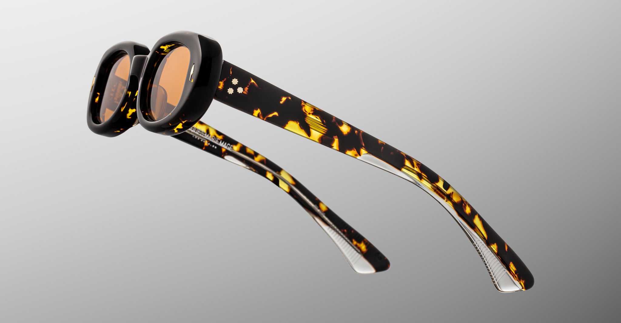 Jacques Marie Mage Besset sunglasses in brown and yellow tortoise shell pattern with orange lenses close-up profile view