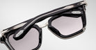 Close-up of Jacques Marie Mage Borodino rectangular sunglasses in black and silver with tinted lenses and prominent metal accents.