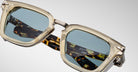 Close-up of Jacques Marie Mage Borodino sunglasses showing translucent beige rims and tortoiseshell-patterned arms.