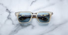 Jacques Marie Mage Borodino sunglasses with blue-tinted lenses and clear frames, front view.
