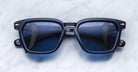 Jacques Marie Mage Borodino sunglasses with blue-tinted lenses, viewed from above.