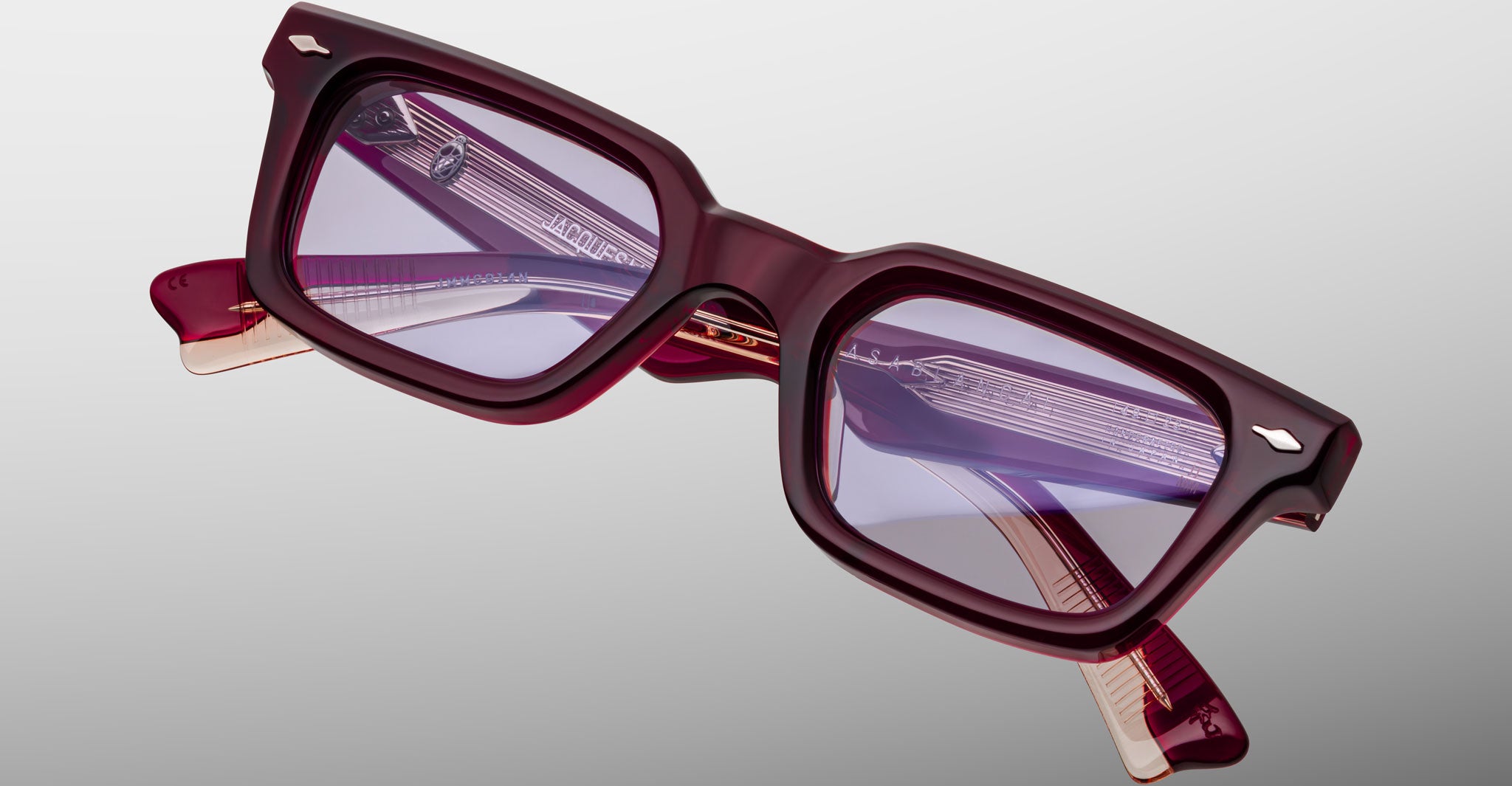 A pair of Jacques Marie Mage Casablanca rectangular eyeglasses with thick burgundy frames and slightly tinted purple lenses, displayed against a neutral background.