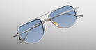 Jacques Marie Mage Cendrars aviator sunglasses with blue lenses and silver frames, front view.