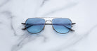 Jacques Marie Mage Cendrars silver aviator sunglasses with blue lenses, front view.