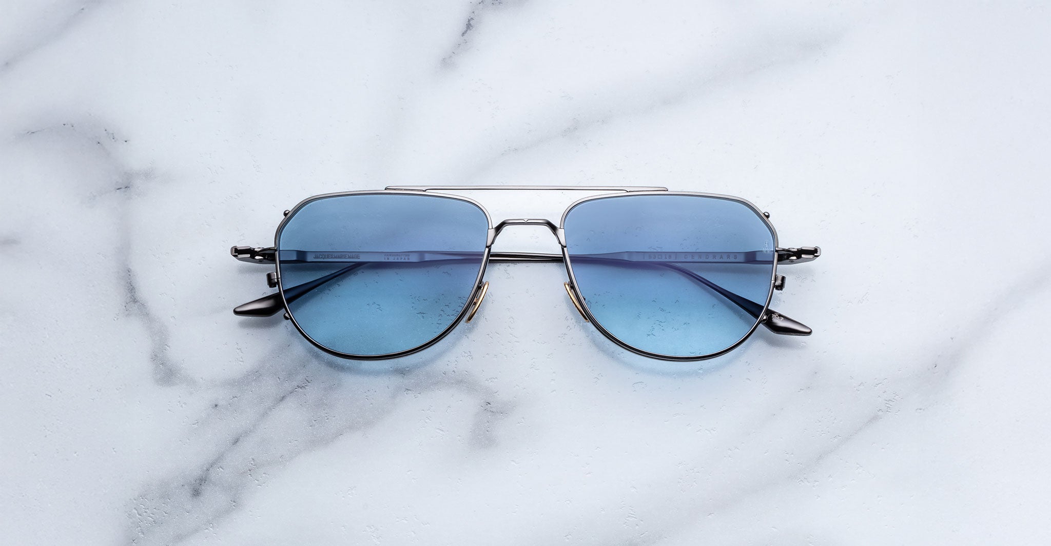 Jacques Marie Mage Cendrars silver aviator sunglasses with blue lenses, front view.