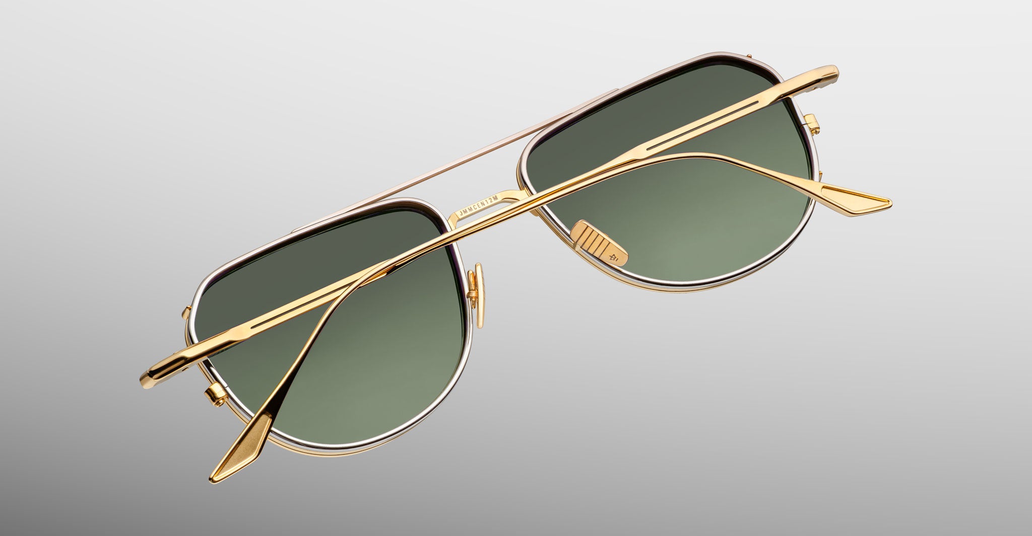 Jacques Marie Mage Cendrars aviator sunglasses shown from the front, featuring gold frames and green lenses.