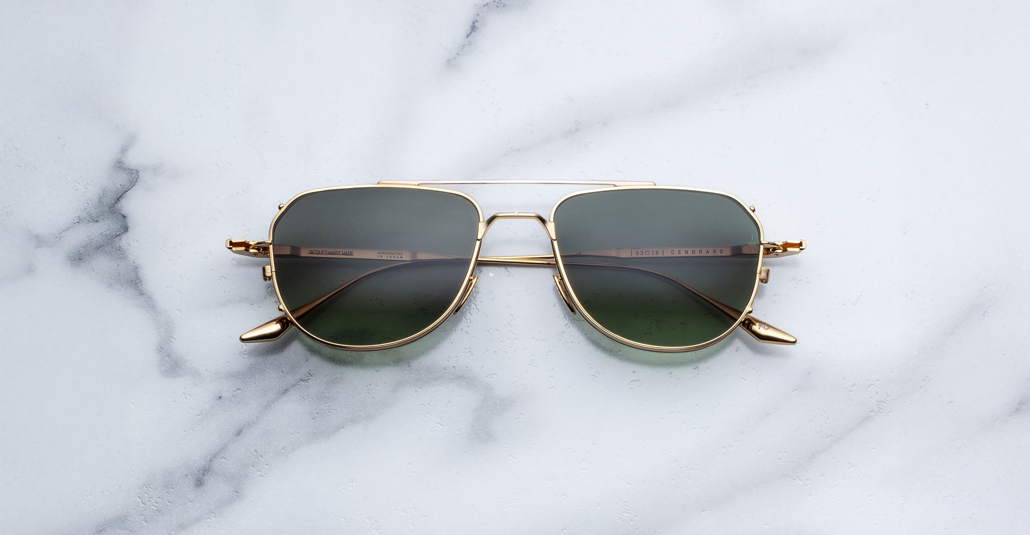 Jacques Marie Mage Cendrars gold aviator sunglasses with green lenses, front view.