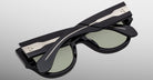 The Jacques Marie Mage Chelsea sunglasses are shown folded, featuring metallic music staff and note details on the temples, set against a light gray background.