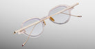 Jacques Marie Mage The Clark eyeglasses with clear frames and gold temples, shown from the front.