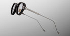 Jacques Marie Mage The Clark eyeglasses, thick black rims, slim metallic temples, shown from the front angle.
