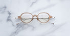 Jacques Marie Mage The Clark round taupe eyeglasses with clear lenses, top view.