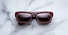 Jacques Marie Mage Cleavon 57 rectangular burgundy sunglasses with dark UV lenses, viewed from above.