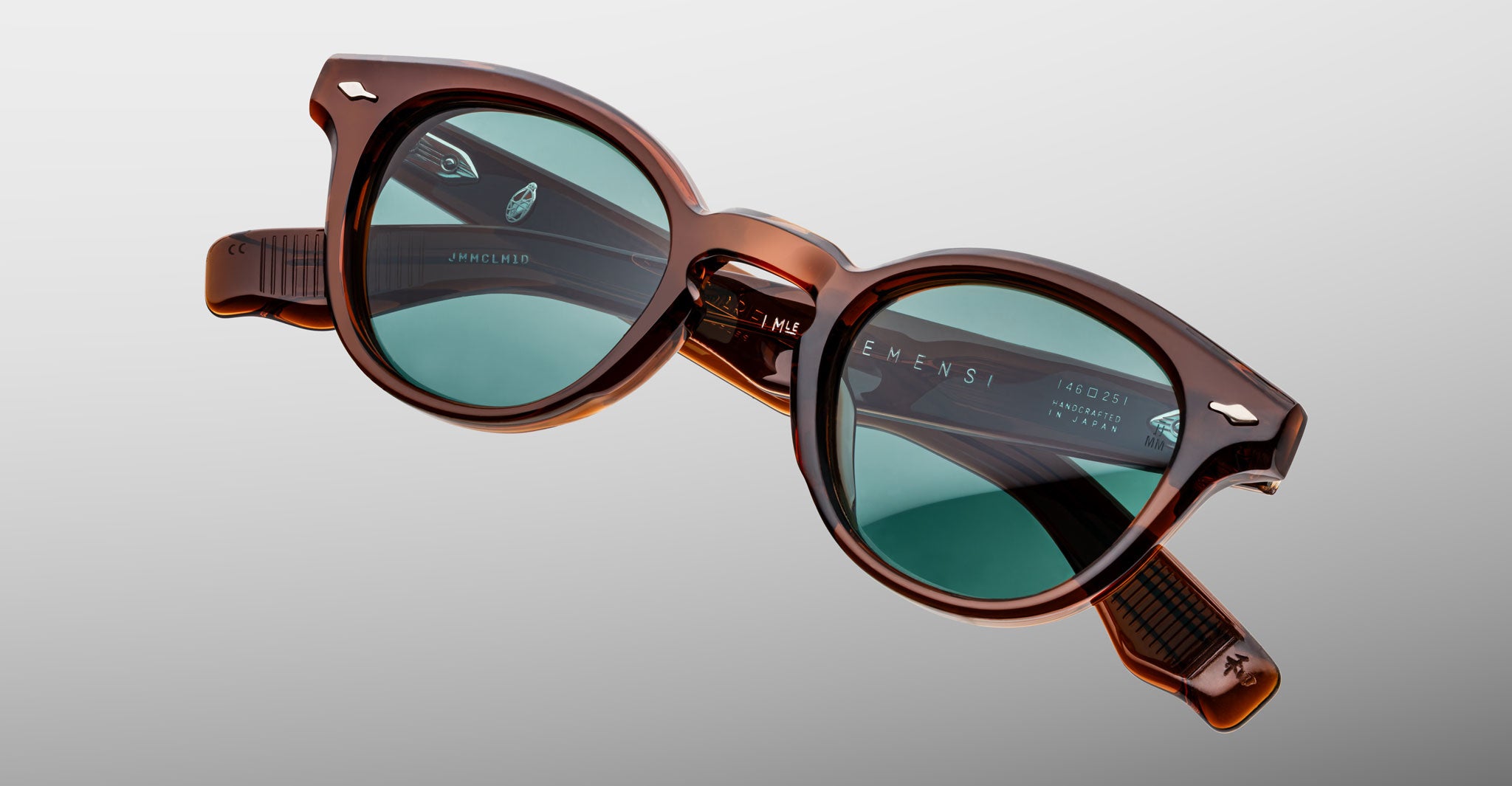 Jacques Marie Mage Clemens in Hickory brown-framed sunglasses with green lenses, front view.