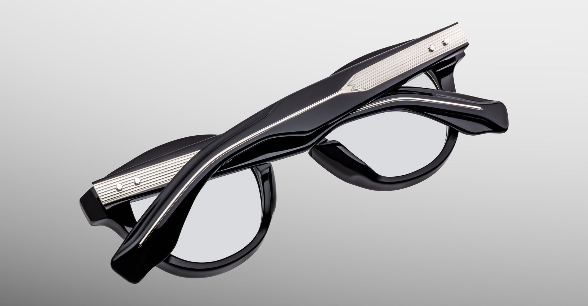 Jacques Marie Mage Clemens in Obscure eyeglasses, black frame with silver metal temple accents, back view.