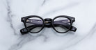 Jacques Marie Mage Clemens in Obscure black round eyeglasses with clear lenses, front view.