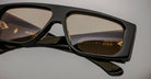 Close-up of Jacques Marie Mage Cliff black rectangular sunglasses with brown lenses, shown from the front.